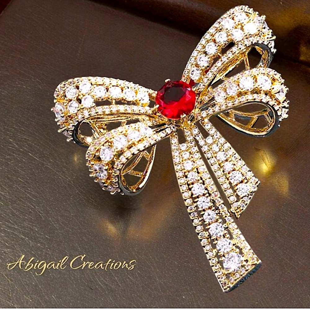 Abigail Creations Vintage
Gold Plated Ruby Crystal and CZ Ribbon Bow Brooch Pin.